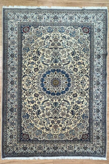 "Elevate your home decor with our exquisite Nain Handmade Rug, meticulously crafted from a luxurious blend of silk and wool. This elegant rug features a harmonious combination of soothing beige and blue tones, exuding a sense of timeless sophistication and refinement. Measuring 310X200 cm, this rug is generously sized to serve as a captivating centerpiece in your living room, bedroom, or study. Its intricate design and premium materials ensure it stands out as a statement piece while seamlessly complementing various interior styles. Crafted by skilled artisans, each knot in this rug is meticulously hand-tied, showcasing a dedication to superior craftsmanship and attention to detail. The blend of silk and wool not only enhances the rug's visual appeal but also guarantees durability and longevity, ensuring it remains a cherished part of your home decor for years to come. Indulge in the understated luxury of our Nain Handmade Rug and transform your living space into a haven of comfort and style. Whether adorning a contemporary setting or adding a touch of elegance to a traditional interior, its timeless design and exquisite craftsmanship promise to elevate your home decor to new heights."