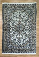 "Indulge in luxury with this Persian Kashan handmade rug. Crafted from super fine wool in a sophisticated cream and brown palette, measuring 310X200."
